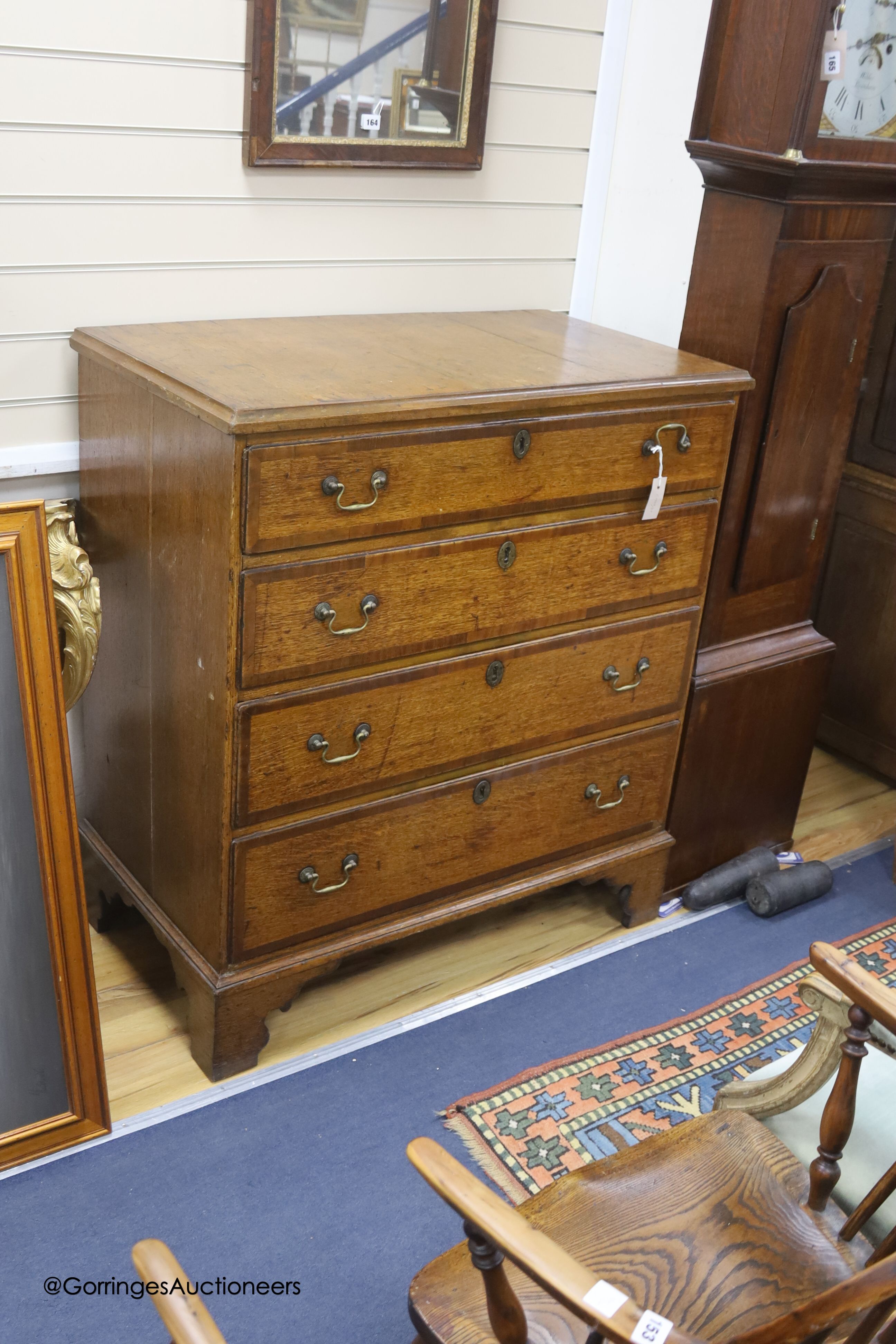 An 18th century oak chest of four graduated drawers